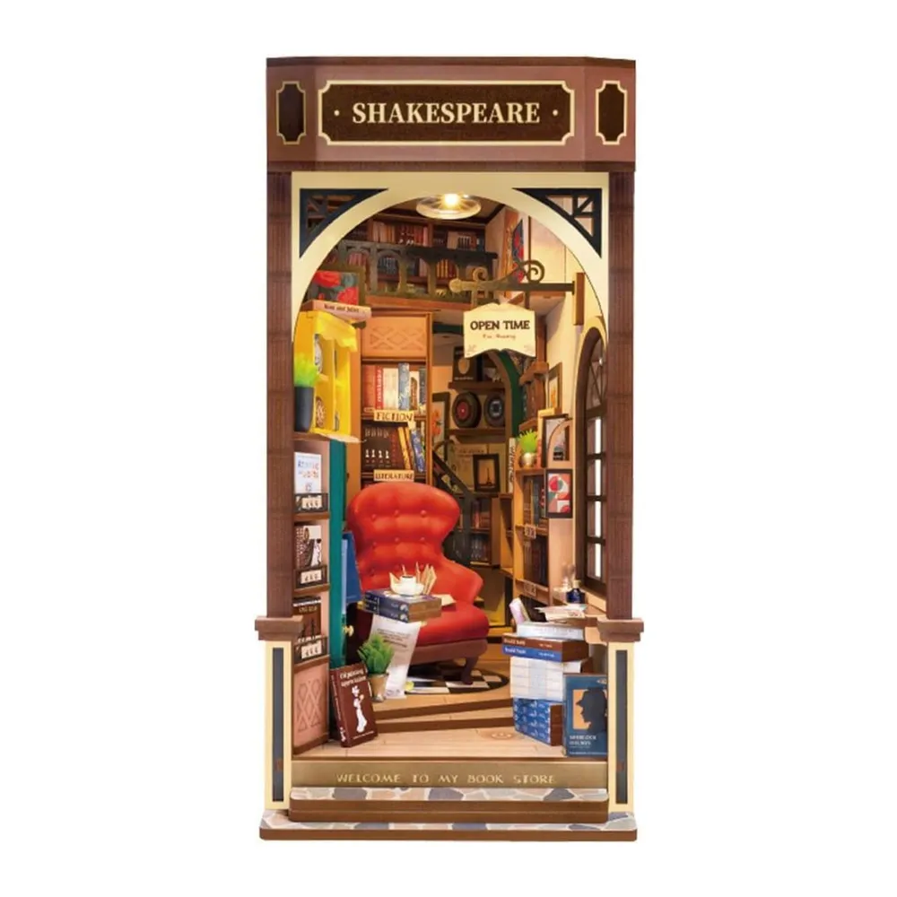 Book nook Librairie Shakespeare monté, enseigne et fauteuil rouge éclairés, sur fond blanc