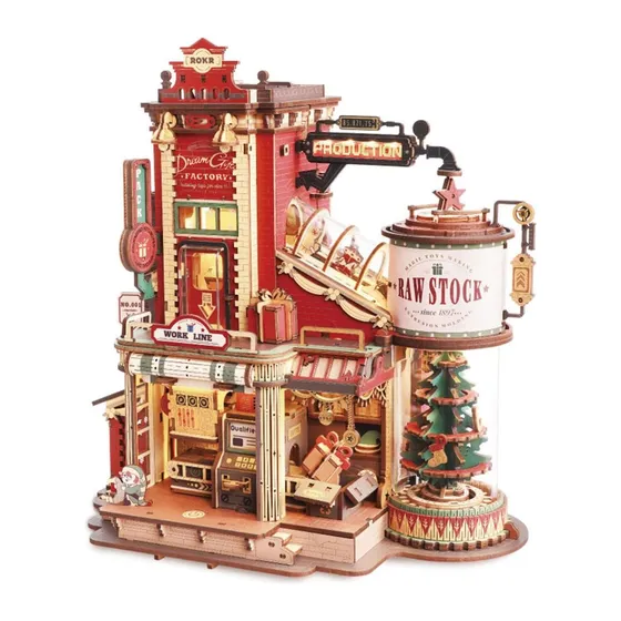Fabrique de cadeaux miniature rouge et or, tour et sapin décoré, sur fond blanc