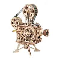 Projecteur Vitascope en bois clair sur son trépied, bobines et courroie apparentes, sur fond blanc