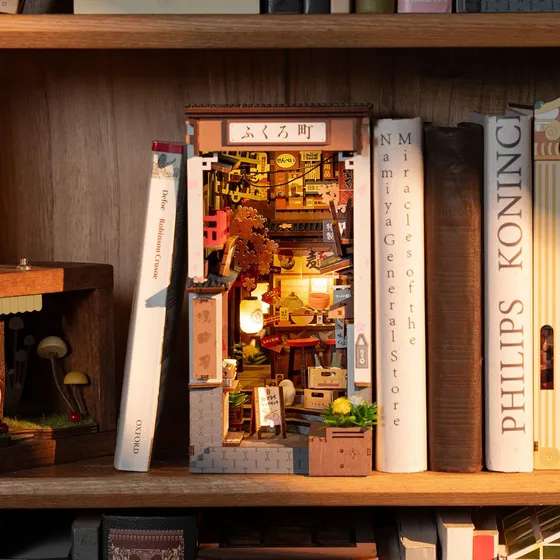 La ruelle éclairée rangée entre des livres sur une étagère sombre