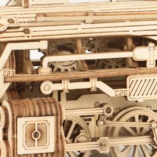 Macro sur la bielle, les engrenages et les roues à rayons d'une locomotive miniature